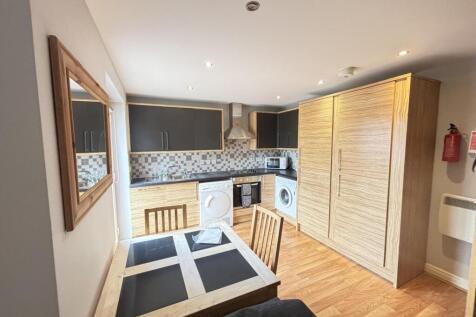 A bright and modern living room featuring a coz...