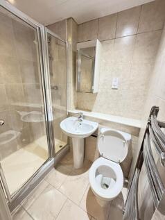 A clean and modern bathroom with a shower enclo...