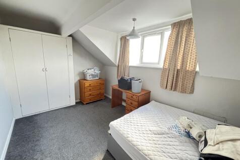 A bright and spacious master bedroom featuring ...