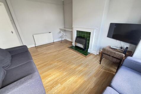 A bright and welcoming living room featuring a ...