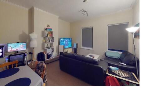 A cozy living room featuring a comfortable sofa...