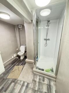 A clean and modern bathroom featuring a shower ...