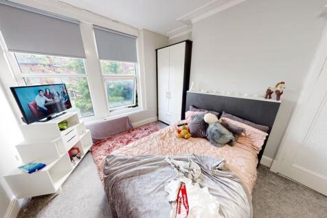 A bright and spacious master bedroom featuring ...