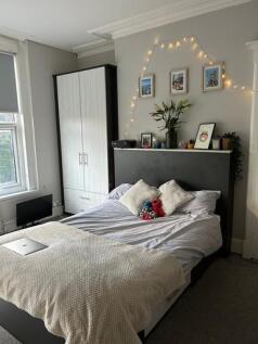 A bright and welcoming master bedroom featuring...