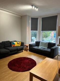 A bright and welcoming living room featuring co...