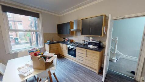 A modern kitchen with ample storage, natural li...