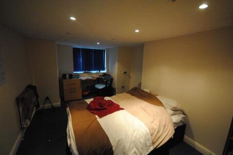 A comfortable bedroom featuring a double bed wi...