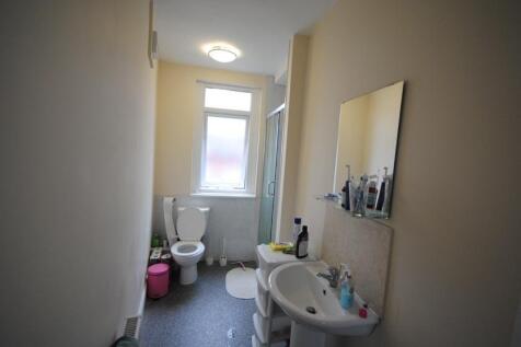 A well-maintained bathroom with a large window ...