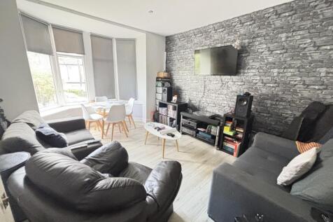 Spacious and modern living room featuring comfo...