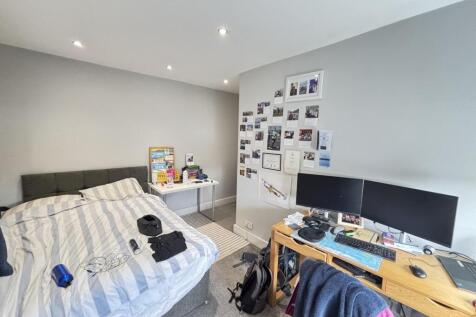 A well-maintained bedroom featuring a double be...