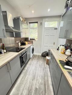 A bright and tidy kitchen with modern grey cabi...