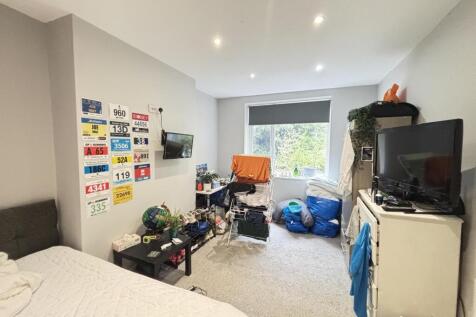 A cozy bedroom with a bed, various personal bel...