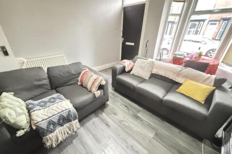 A spacious and well-lit living room with modern...