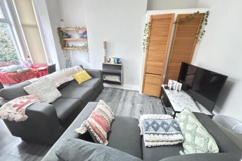 A bright and spacious living room featuring a l...