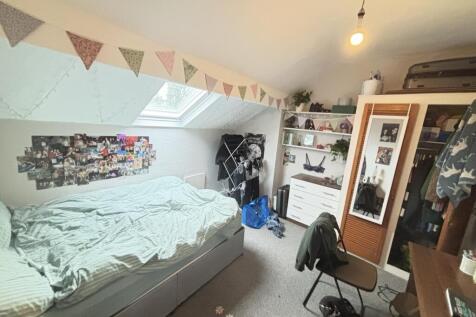 A cozy bedroom featuring a double bed and a war...