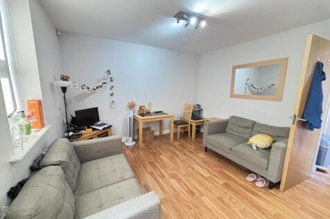 A spacious and bright modern living room featur...