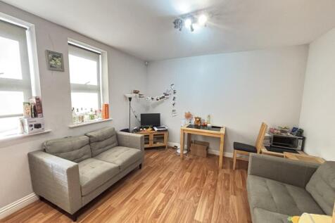 A bright and welcoming living room featuring co...