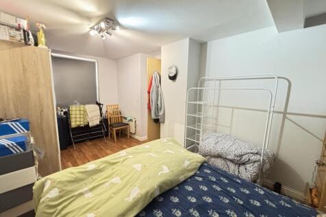A cozy and well-maintained bedroom with a simpl...
