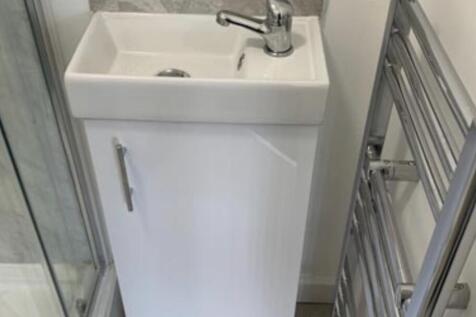 A clean and well-maintained bathroom featuring ...