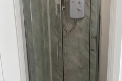 A well-maintained bathroom featuring a shower u...