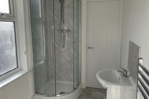 A spacious and clean bathroom featuring a large...