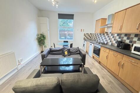 A spacious and well-lit living room with modern...