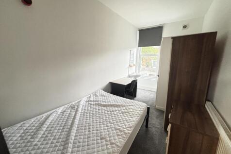 A neatly maintained bedroom featuring a double ...