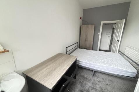 A cozy bedroom featuring a double bed, a wardro...