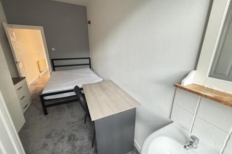 This image displays a small bathroom area featu...