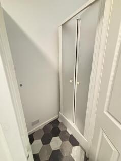 Neat small storage/utility alcove with patterne...