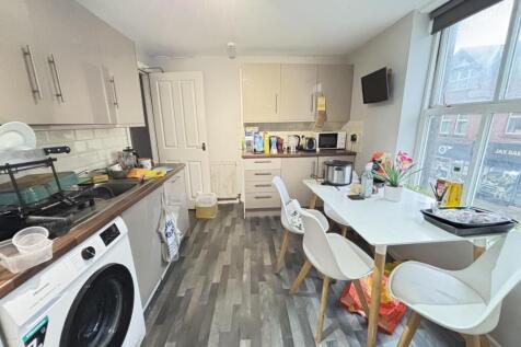 Bright and modern living room with ample natura...