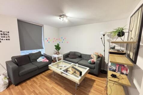 A bright and spacious living room featuring two...