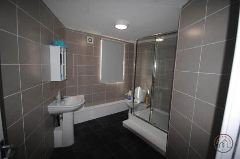 Bright and modern bathroom suite featuring a sp...