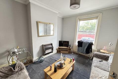 A bright and inviting living room with large wi...