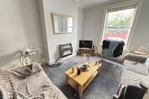 Bright and inviting living room with ample natu...