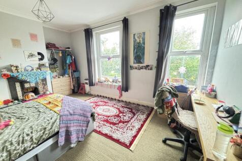 Bright and welcoming living room with large win...