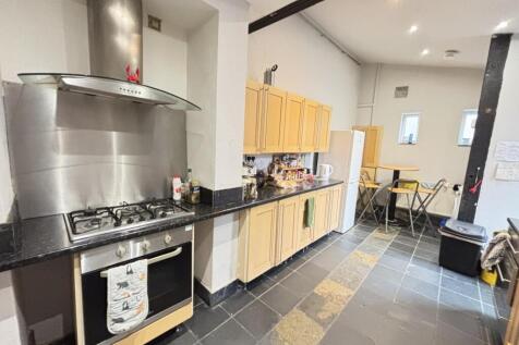 A modern and clean kitchen area featuring woode...