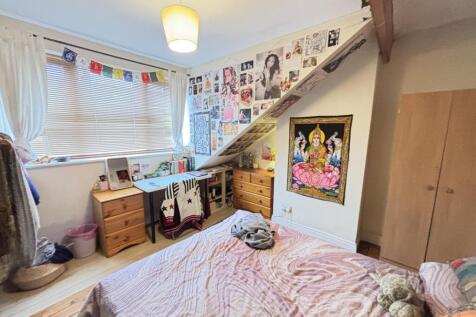 A bright, well-decorated bedroom featuring a co...