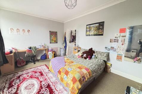 A cozy and well-maintained bedroom with natural...