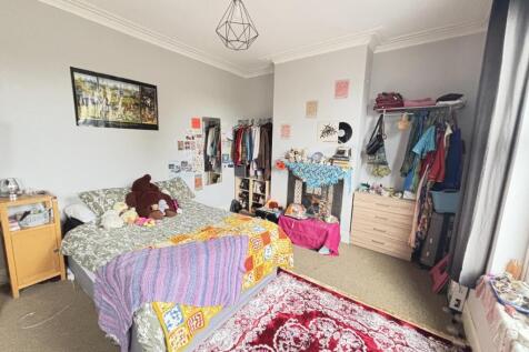 A cozy bedroom with a single bed and colorful b...