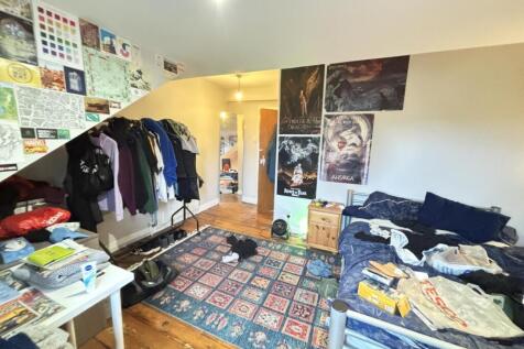 A cozy living room with a large, inviting seati...