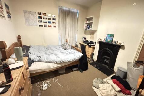 A cozy bedroom featuring a double bed, with nat...