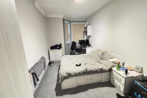 A spacious master bedroom featuring a double be...