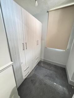 A cozy, well-maintained bedroom with a large wa...