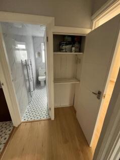 Bright, well-maintained hallway with wood-effec...