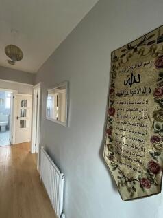 Bright, tidy hallway with light wood flooring, ...