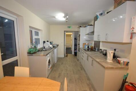 A spacious and well-lit kitchen with modern app...