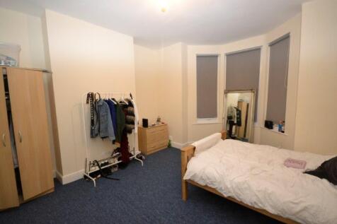 A tidy double bedroom featuring a bed, wardrobe...