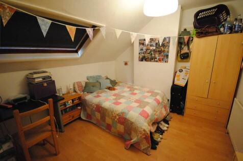 A spacious and inviting master bedroom featurin...