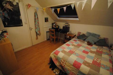 A cozy bedroom featuring a double bed with a co...